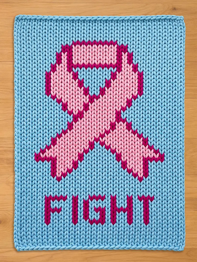 A knitted blanket in light blue features a pink ribbon design, a symbol of support. The word "FIGHT" is displayed in pink letters below the ribbon. The item is made of a textured, knitted material.