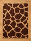 Chunky knit blanket featuring a brown and cream giraffe print pattern.