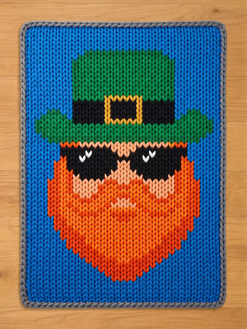 Chunky knit blanket featuring a leprechaun face with an orange beard, green top hat, and black sunglasses on a bright blue background