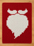 Chunky knit red blanket featuring a large white Santa beard and mustache silhouette